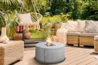 Runde Feuerstelle aus Edelstahl im Garten als Dekoelement