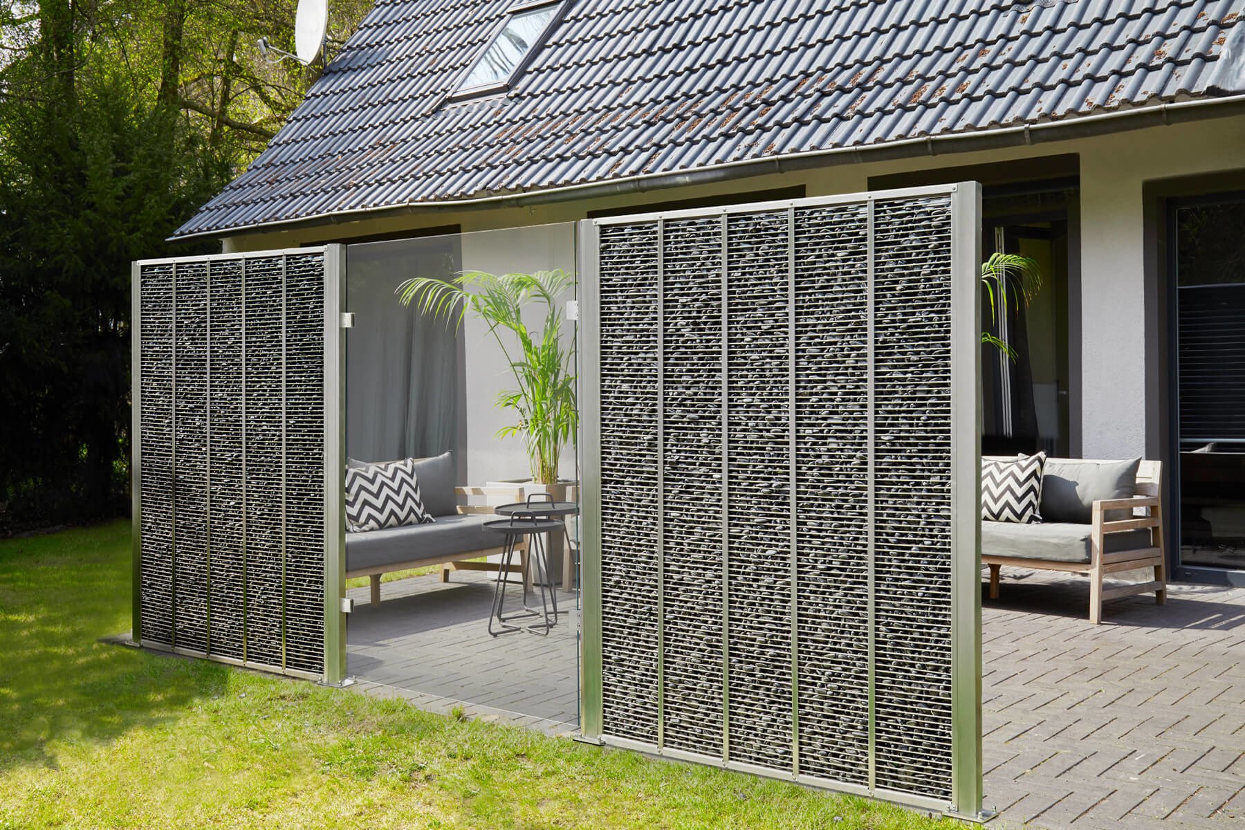 Moderner Gabionenzaun mit Cortenelement kombiniert schützt Garten und Terrasse vor Wind Blicken und Lärrm